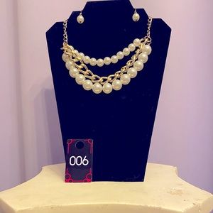 This is a short necklace with beautiful Pearl like beads and gold color chain.
